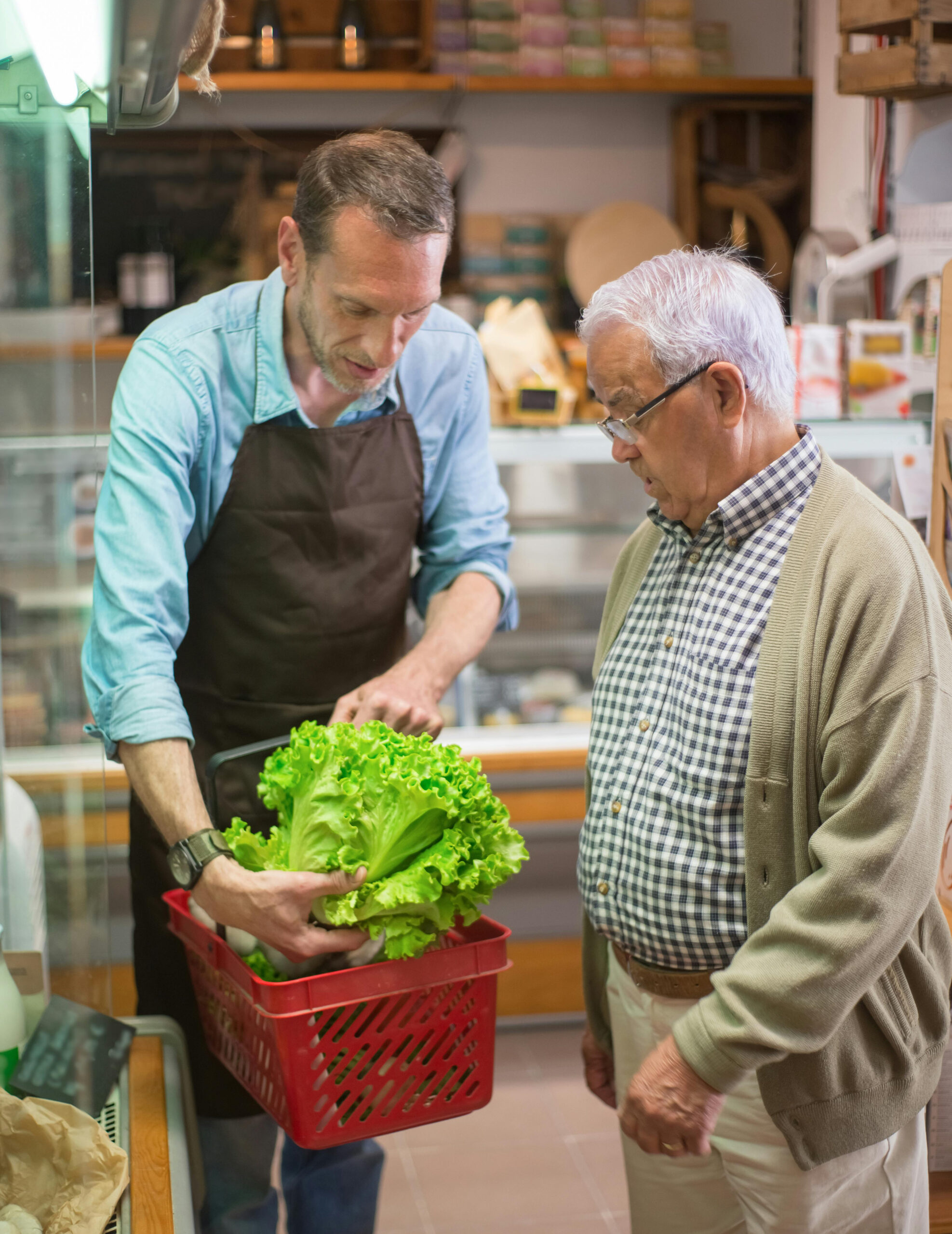 Grocery store clerk assists customer